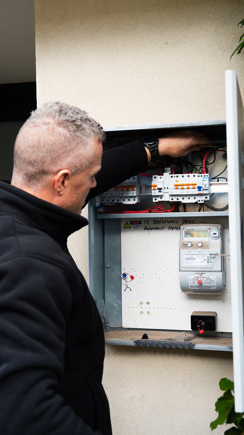 Electrician inspecting a switchboard
