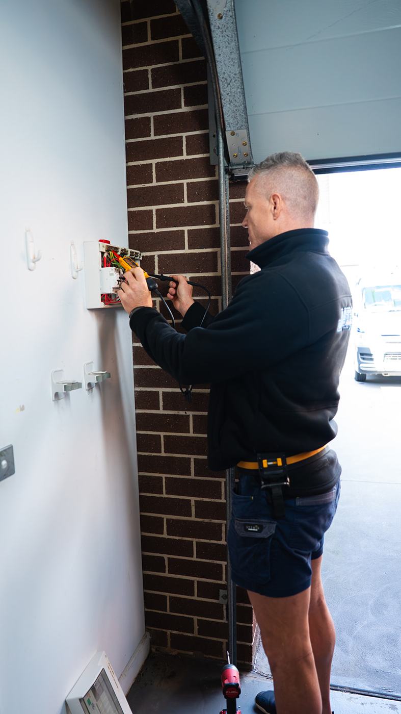 Electrician working on an external switchboard