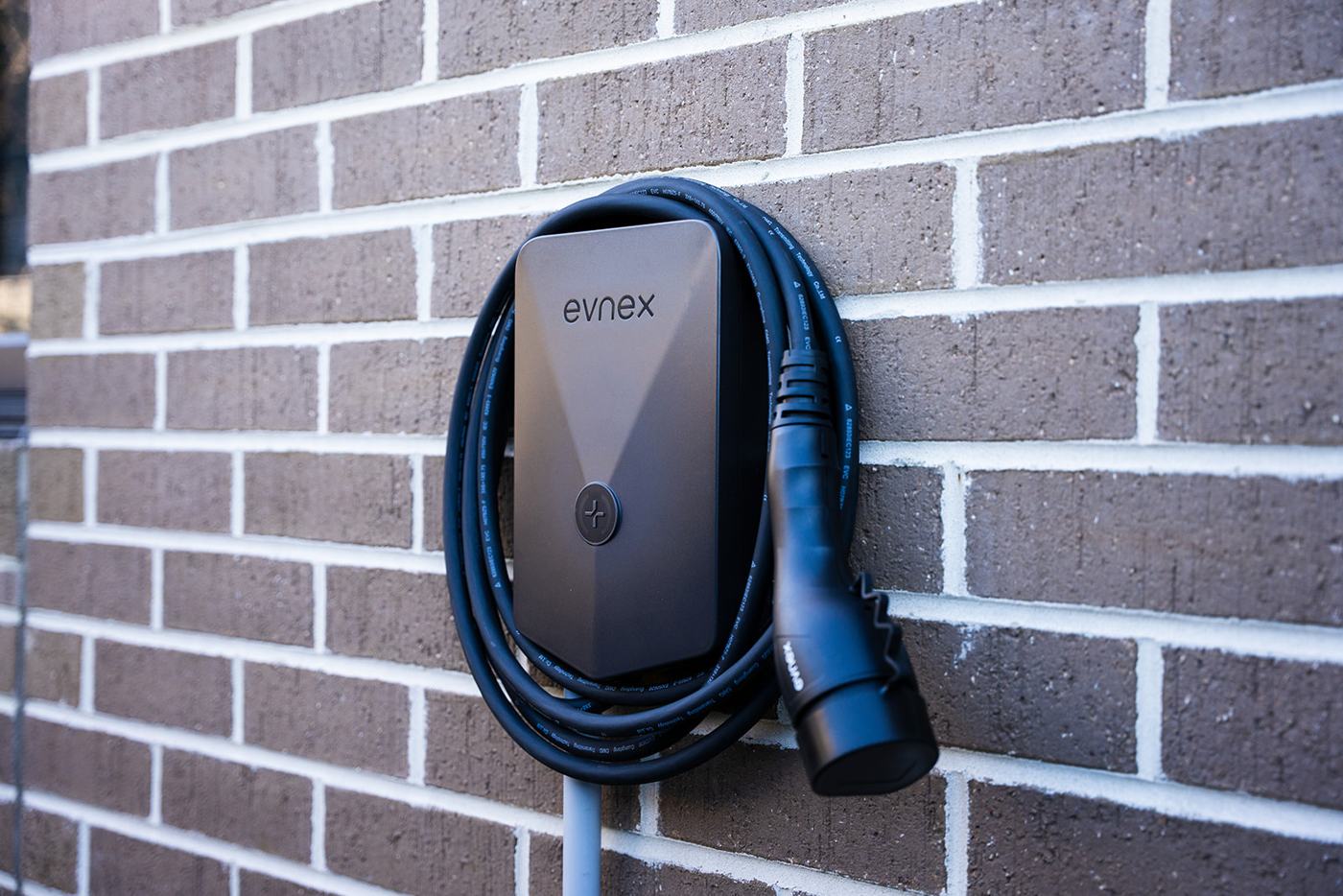Close-up of a wall-mounted EV charger installed by JAT Electrics