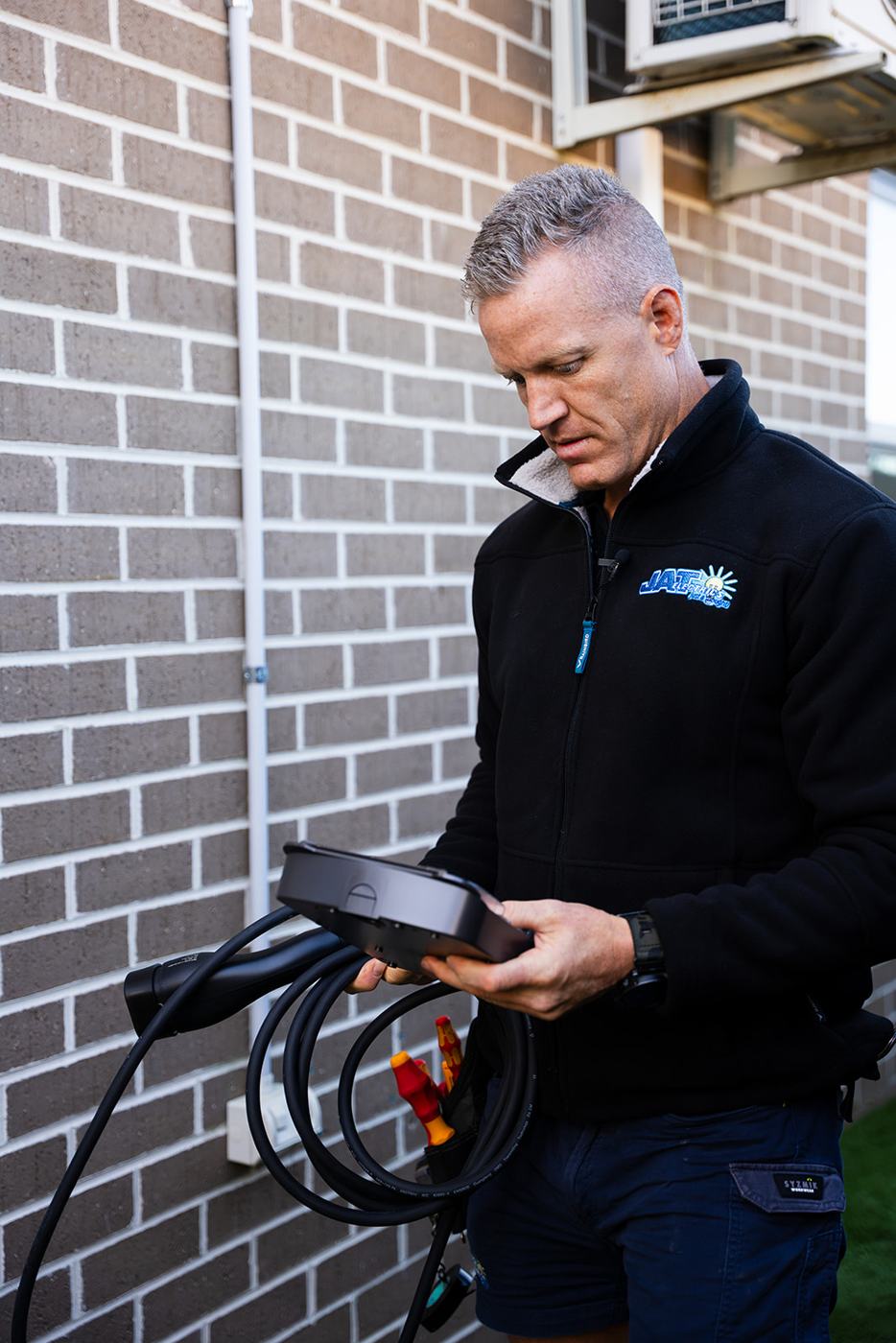 Electrician holding an EV charger cable